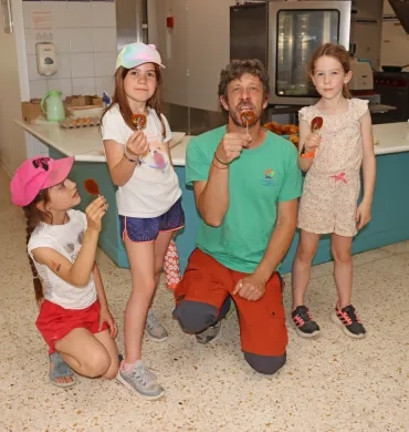Un groupe d'enfants et leur animateur montrent des sucettes