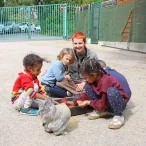 Un groupe d'enfants et leur animatrice mélangent des graines